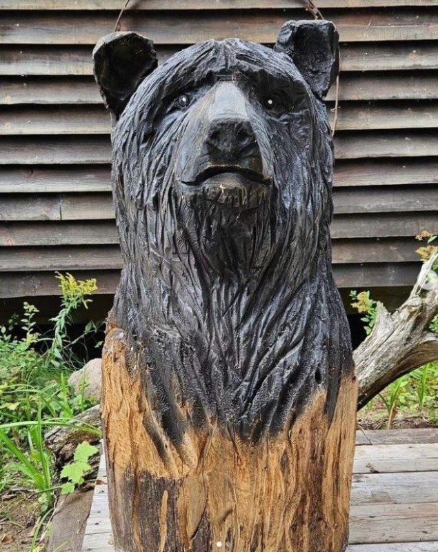 wood carving of black bear from the neck up
