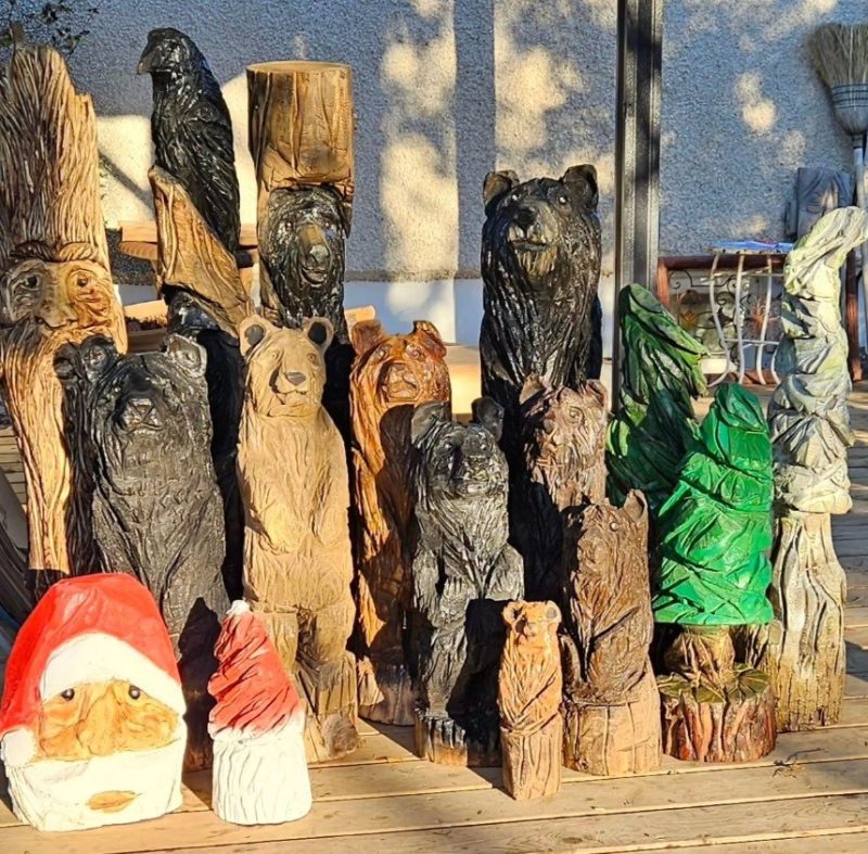 A variety of wood carvings - bears, birds, trees, santa